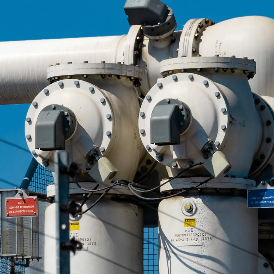 two big white pipes with labels on the flanges