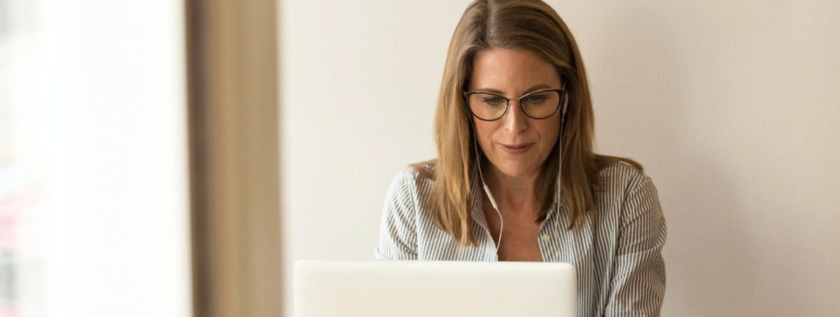 a woman in a office working on a laptop